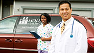 Doctor and nurse next to Molina Healthcare van