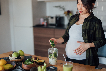 pregnant woman making healthy drink