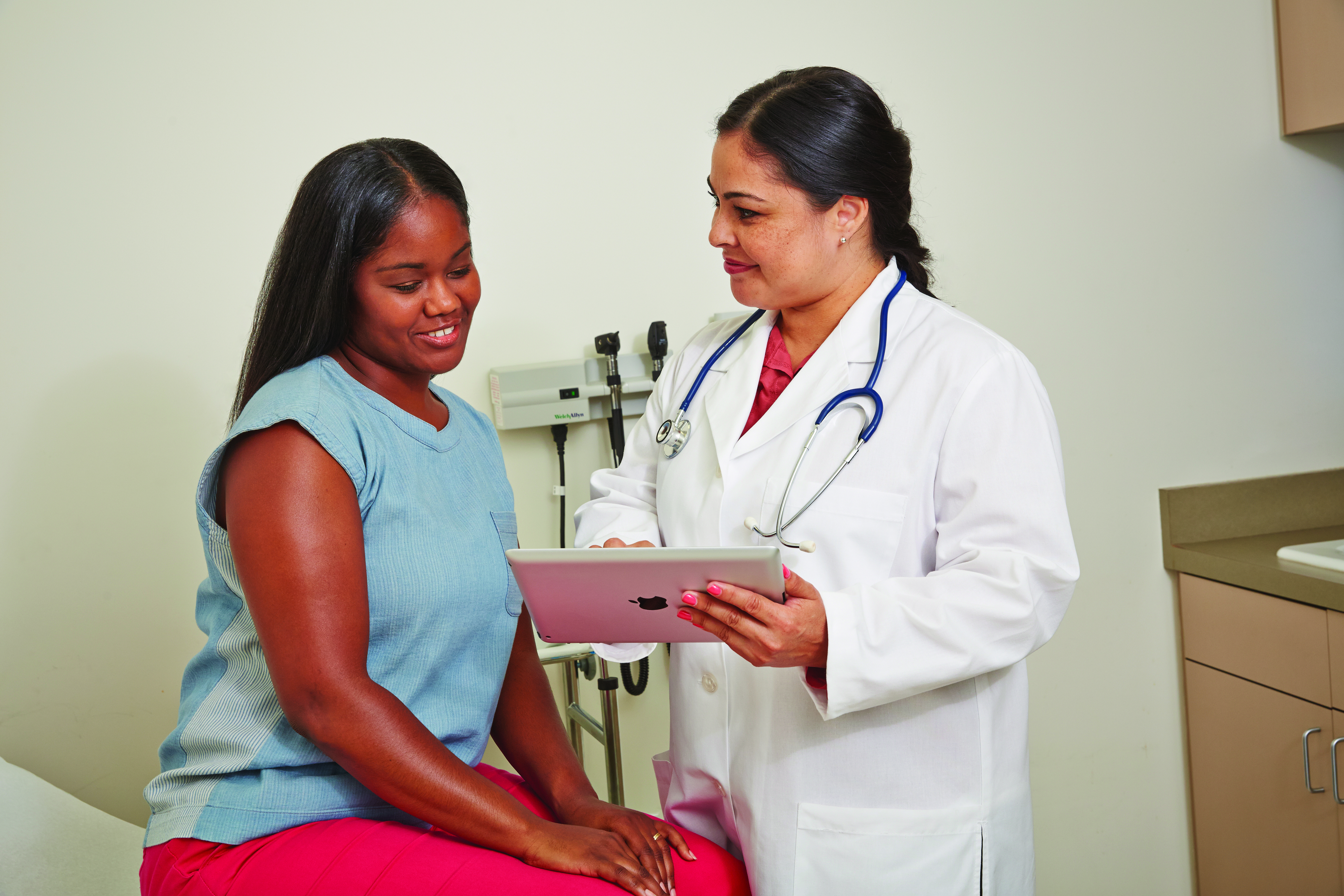 Patient and doctor reviewing screening procedure. Patient and doctor reviewing screening procedure.