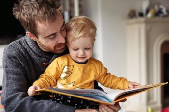 Adult reading to child. Adult reading to child.