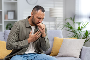 man coughing