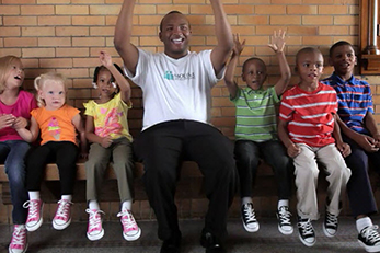 African American man sitting with children