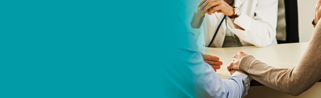 people holding hands and talking to doctor