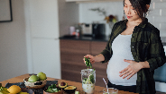 pregnant woman making a healthy drink
