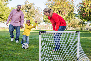 Family playing soccer.